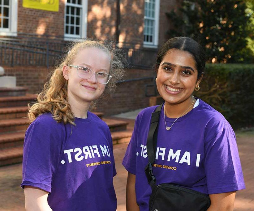 Two Converse first-generation students smiling on campus.